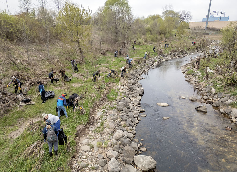 Volunteers spread out along a stretch of the KK River just east of 6th Street.