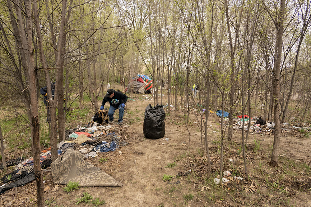Dirk, a member of StreetLife Communities, cleaning up a homeless encampment near the KK River. The regular cleanup volunteers were asked to avoid these areas. 