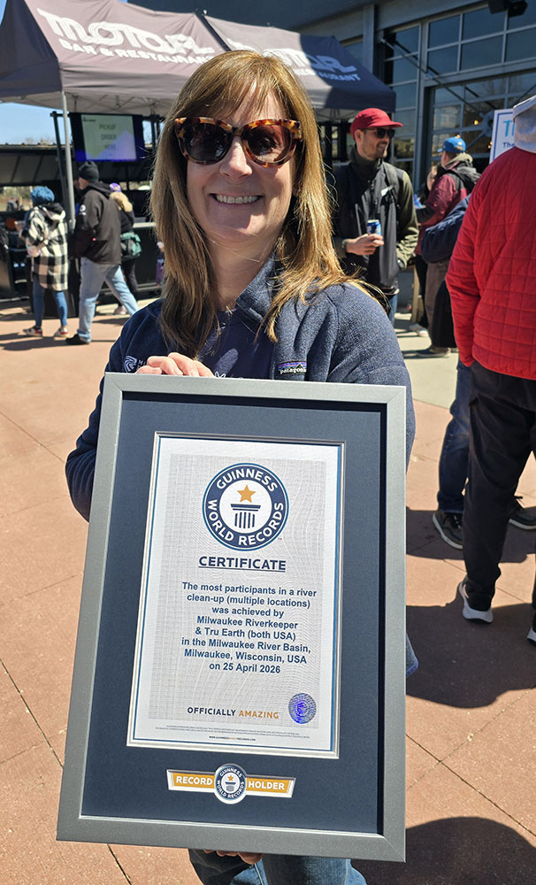 Milwaukee Riverkeeper's Jennifer Bolger Breceda with the official Guinness World Record certificate at Rock the Green following the cleanup.