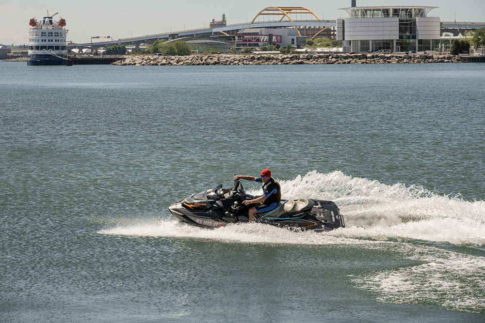 A jetskier roared up and down in the harbor along the edge of the park.