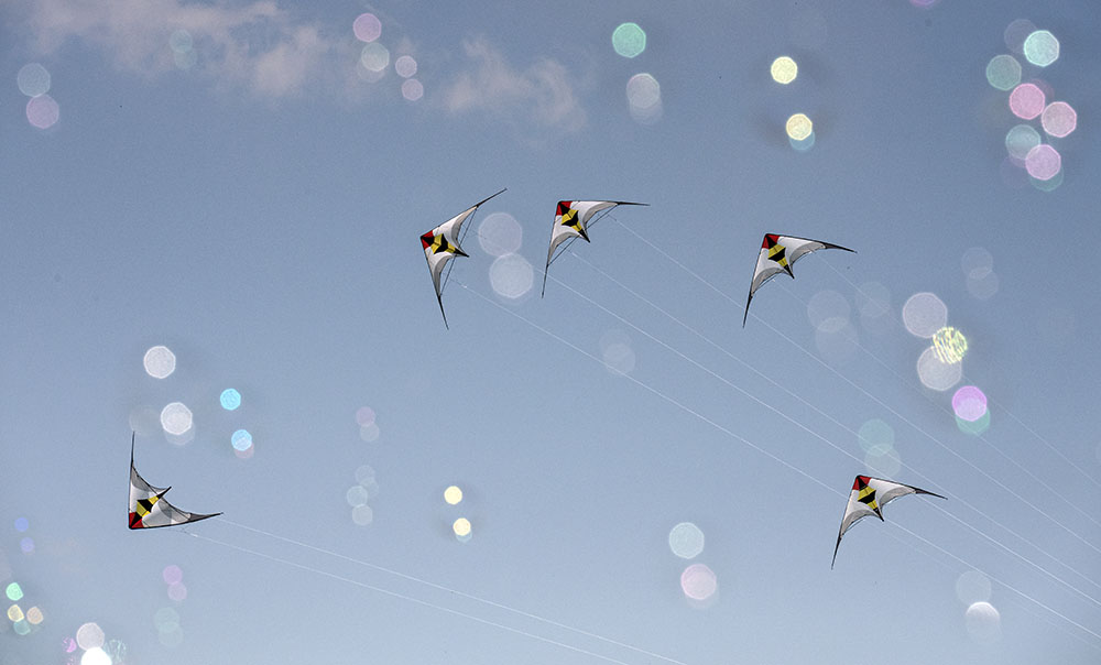 Kite show seen through bubbles.