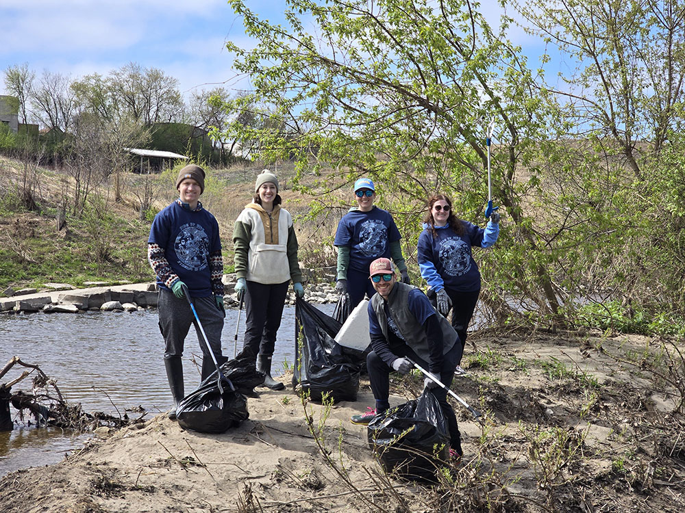 Volunteers on a sandbar in the Menomonee River next to Three Bridges Park. 