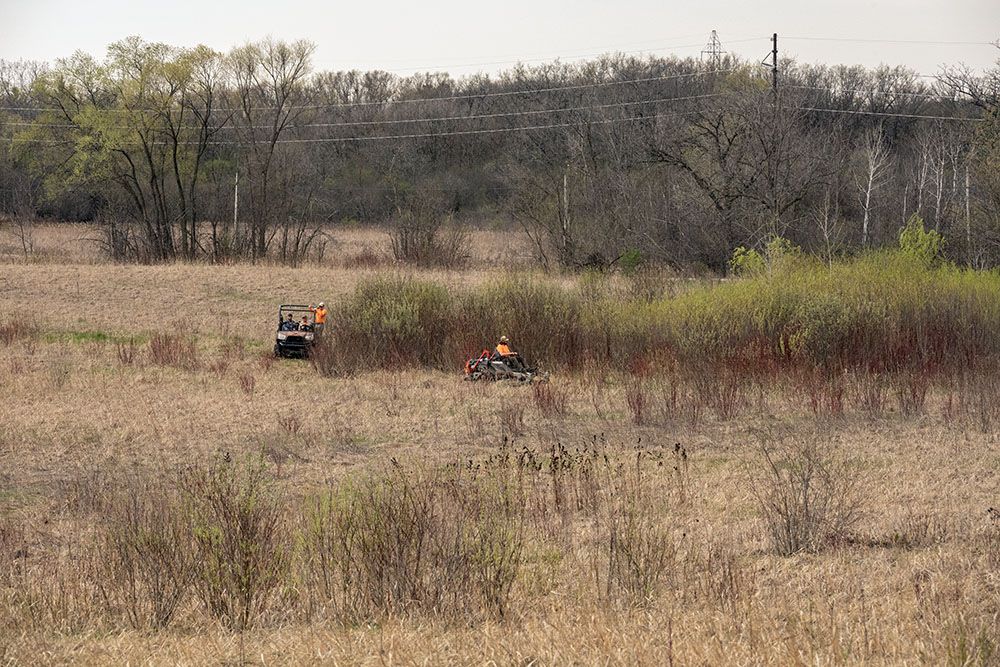 Burn crew mowing a firebreak around the entire preserve.