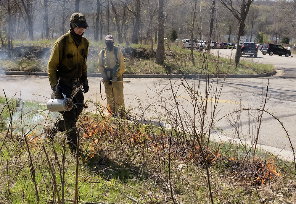 Initial ignition in the southwest corner of the prairie in obvious proximity to the parking lot.