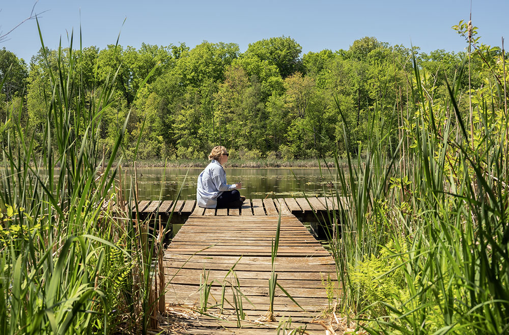 Wendi sketching on the dock at Huiras Lake. 
