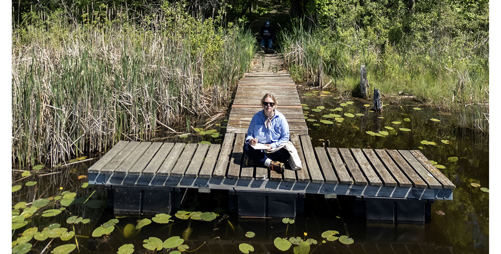 Artist in Residence Wendi Turchan-Martin on the dock at Huiras Lake