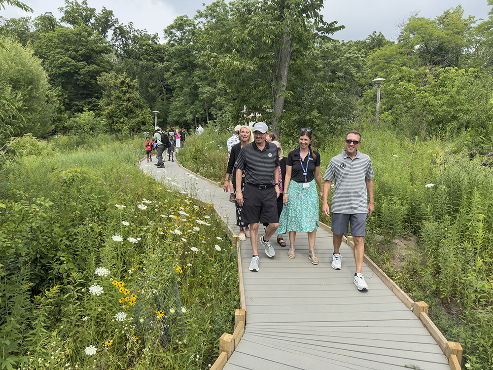 Milwaukee County Parks Executive Director Guy Smith (front, left) and other officials inaugurate a new All Abilities Tail loop at Wehr Nature Center on July 26, 2026.