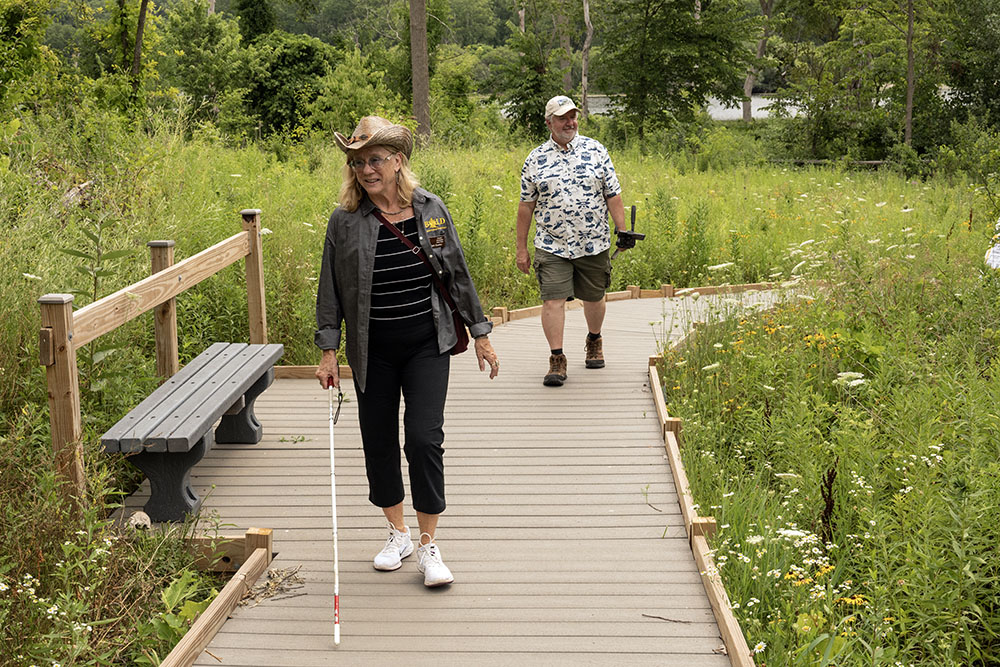 A visually impaired visitor tries out the new boardwalk.