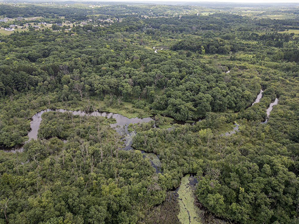 An aerial overview from the south showing most of the county property with the river meandering through it.