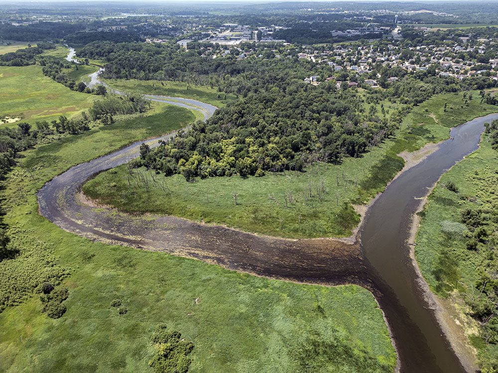 The confluence of the Mukwonago River (left) with the Fox River, into which it drains over 47,000 acres of watershed. The Fox River flows south until it meets the Illinois River. While the Mukwonago River appears in this photo to be as large as the Fox, it is far shallower.