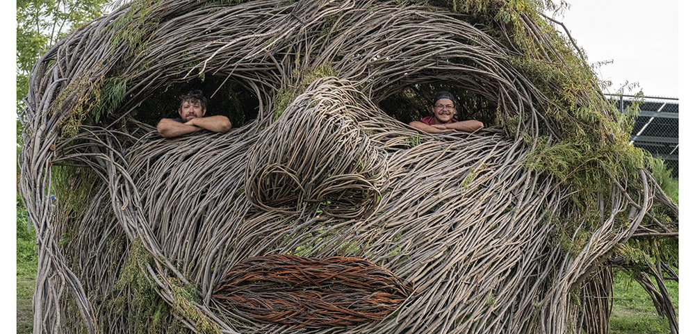 Artists Justin Roberts and Nathan Kennedy inside the sculpture Sacred Rhythm Mother