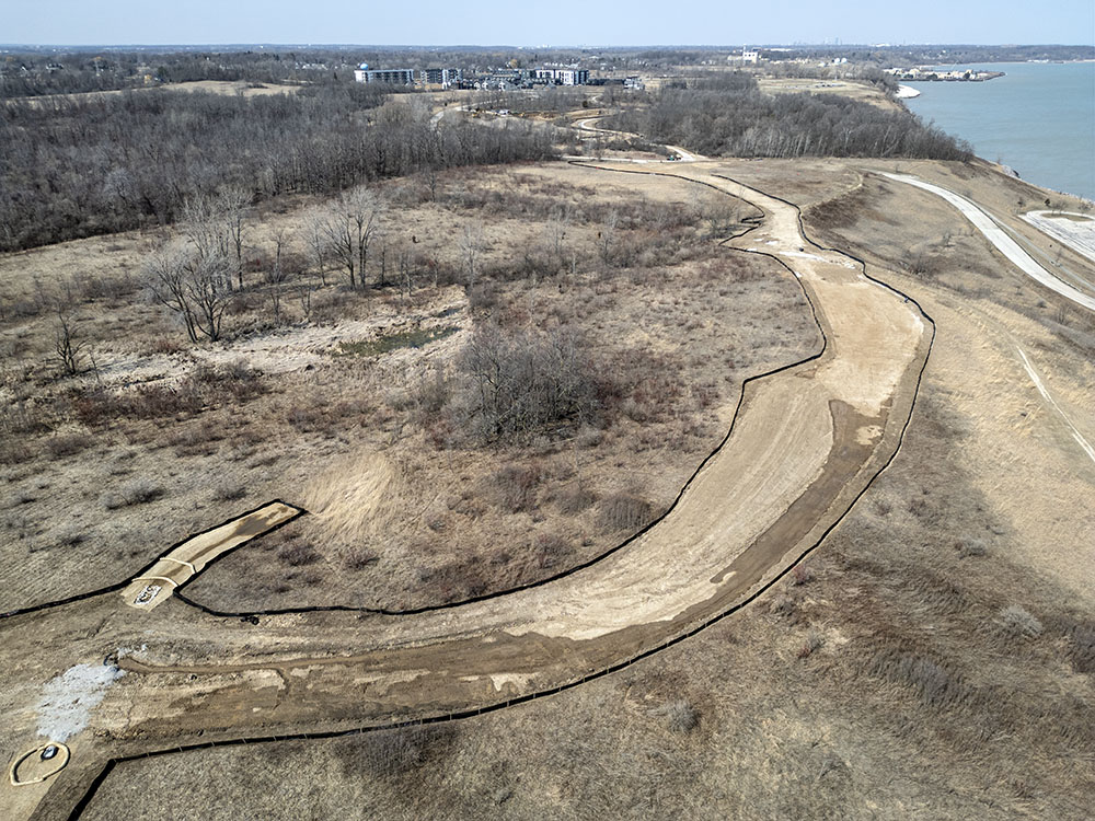 This aerial view shows the northern half of the park and the cleared and fenced construction corridor.