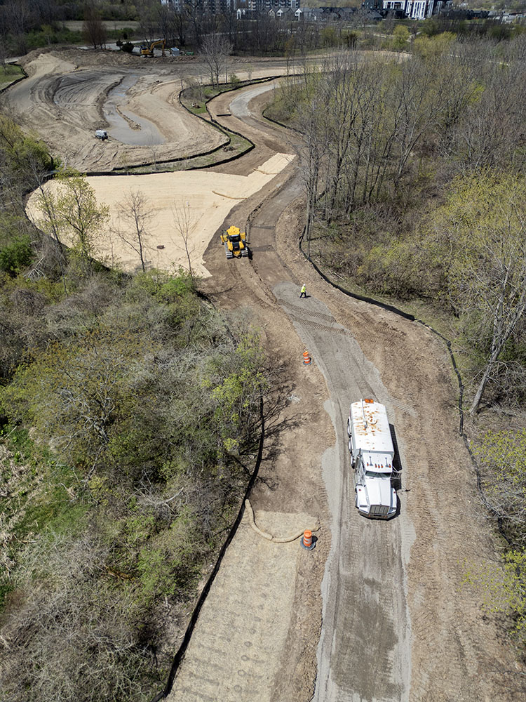 The foliage is just beginning to bud into green in April as work continues, here at the north end of the park.