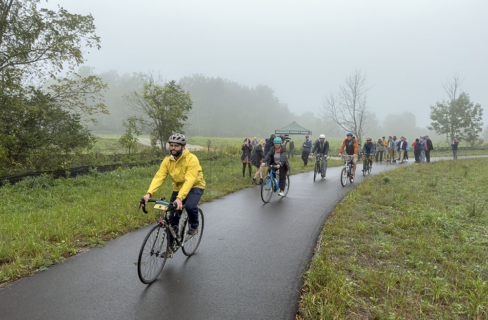 Milwaukee County Parks Trails Coordinator Jacob Sanchez leads a contingent of cyclists on an inaugural ride on the newly opened trail.