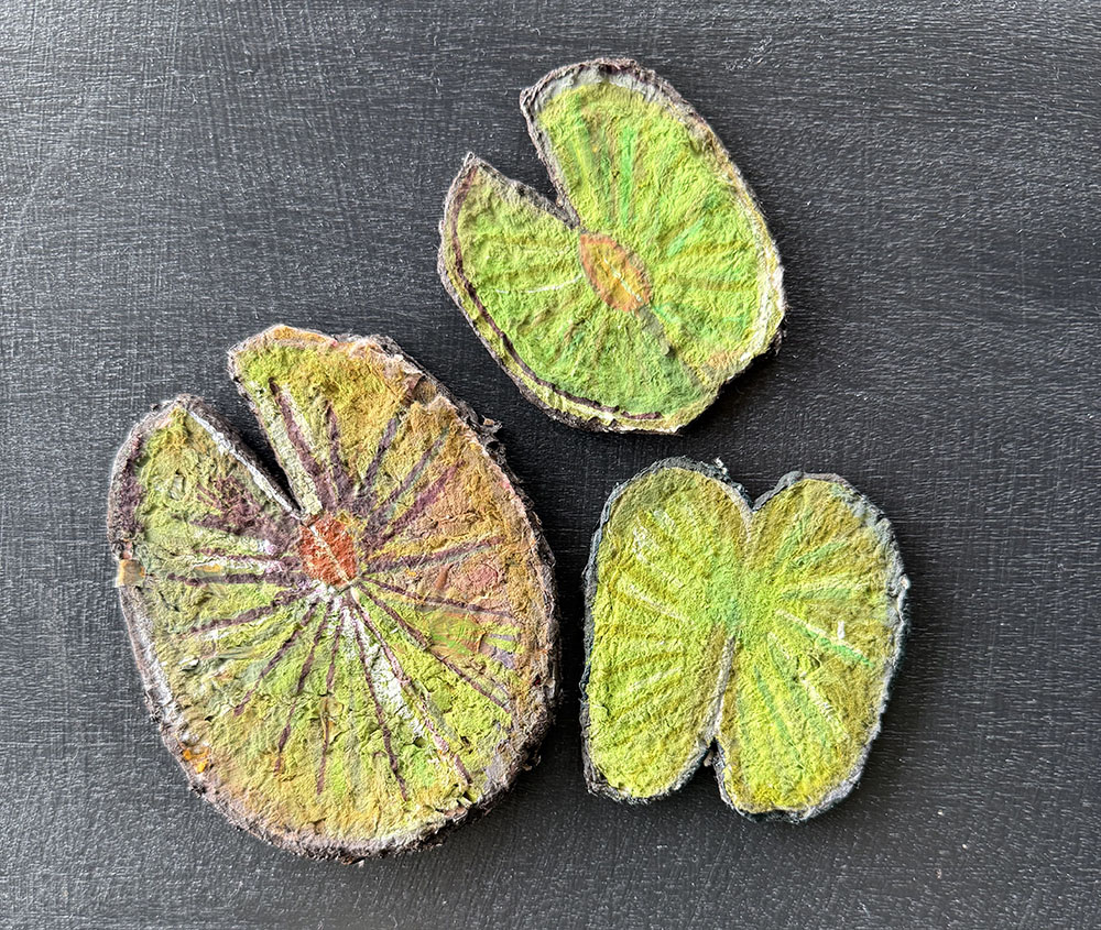 Finished and cut out hand-made paper lily pads.