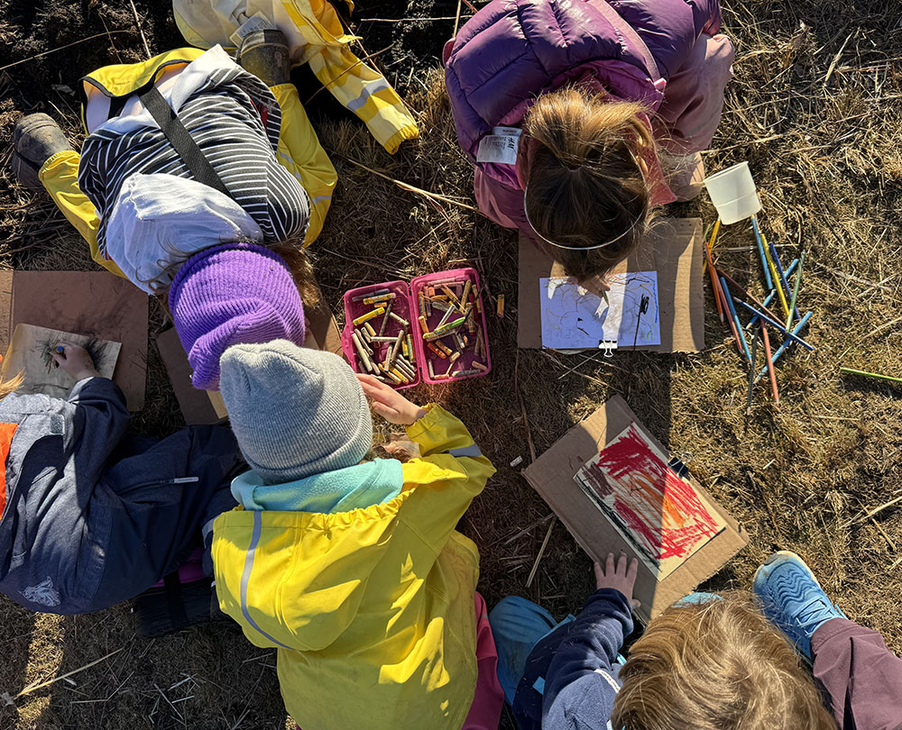 Students explore different mediums (oil pastels, colored pencils) along with charcoal and ash from the prairie burn.Photo courtesy Schlitz Audubon Nature Center.