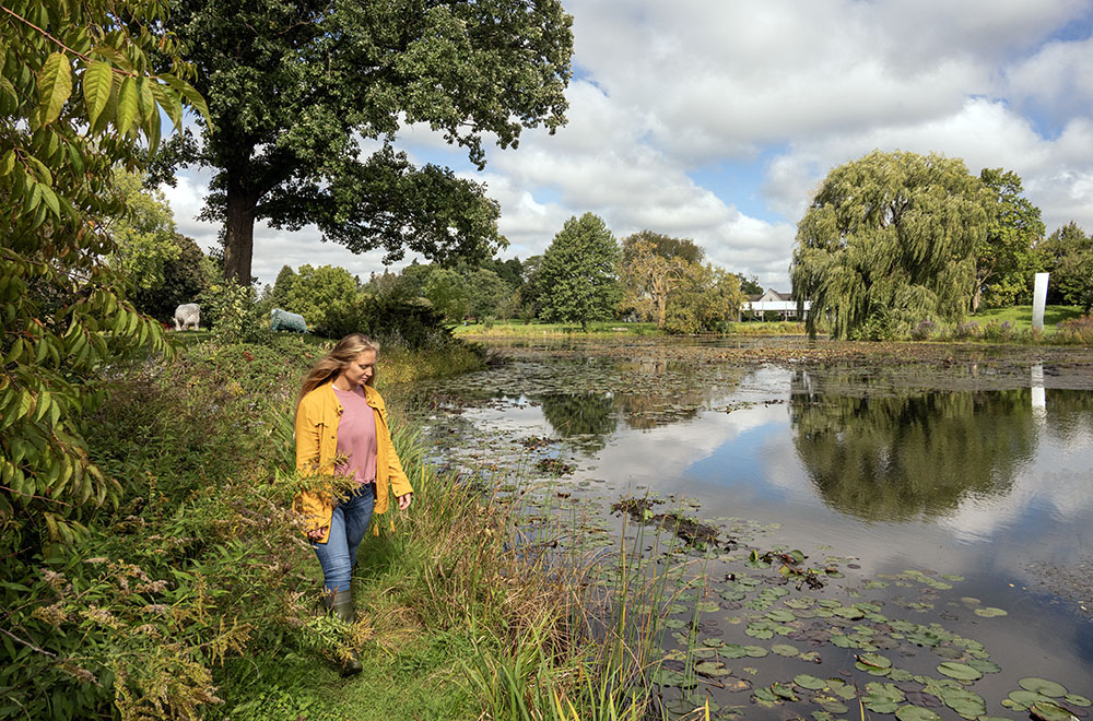 Julie walking beside the pond at Lynden Sculpture Garden. Photo by Eddee Daniel.