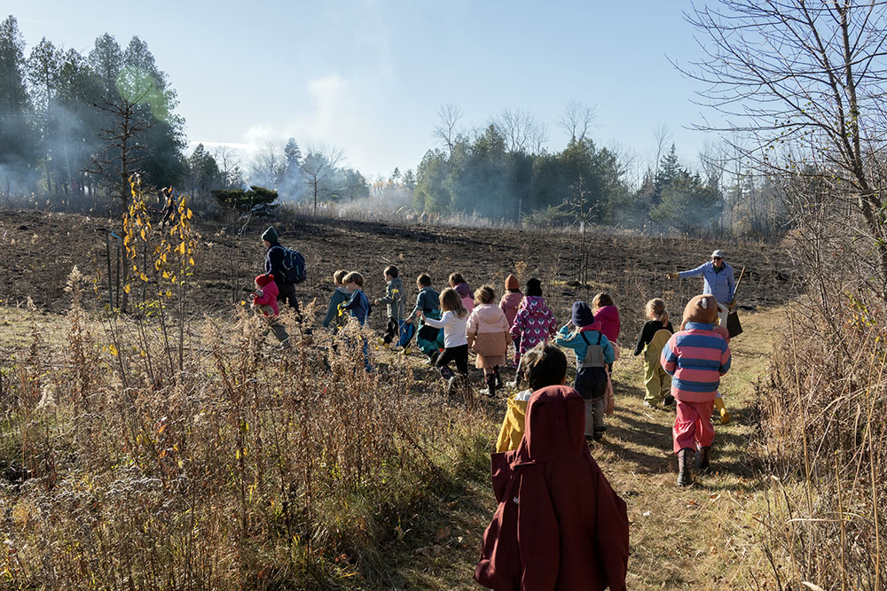 A class of preschoolers approaching the burn, accompanied by their teachers.