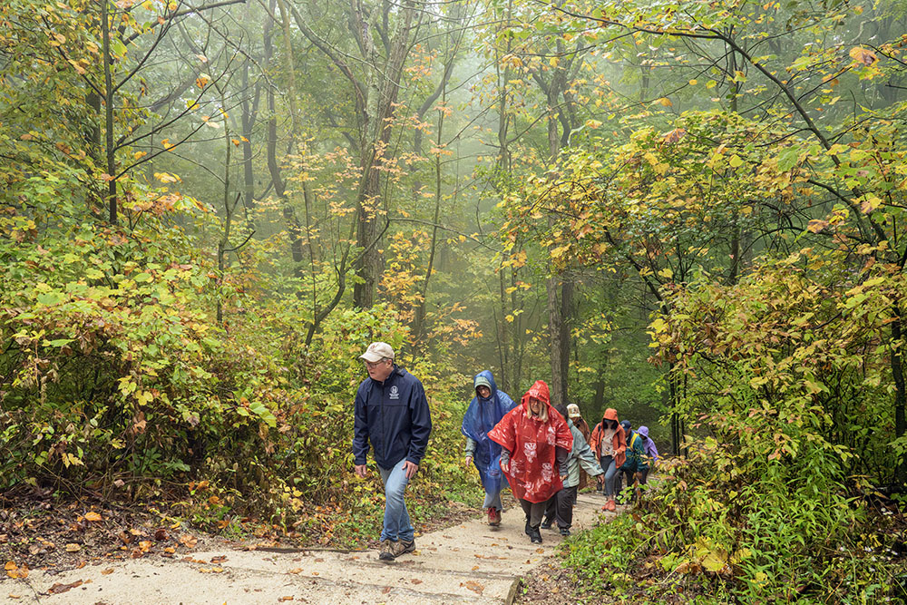 Schlitz Audubon guide Tom Finley leads the group up the steep incline to reach the Parnell Tower.